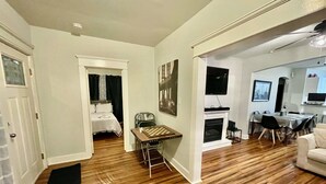 A spacious living area with hardwood flooring, a dining table, and a fireplace. - BEST⭐️6 SLEEPS+|3 BDR ENTIRE HOME💖FREE PARKING#Pet Friendly|Near Beaches CASINO (Atlantic City)