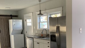 A kitchen with white cabinets, a stainless steel refrigerator, a dishwasher, and a window with a view of a house. - BEST⭐️6 SLEEPS+|3 BDR ENTIRE HOME💖FREE PARKING#Pet Friendly|Near Beaches CASINO (Atlantic City)