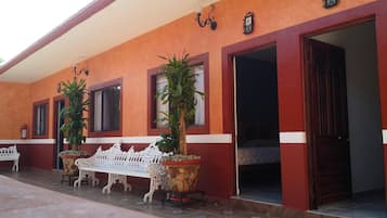 Basic Quadruple Room, 2 Queen Beds | Living area | 32-inch flat-screen TV with cable channels, TV