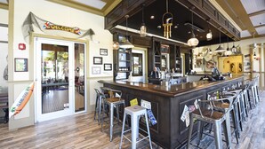 A bar area with stools, a counter, and a 'Welcome' sign.