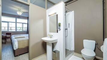 A modern bathroom with a shower, toilet, and sink.