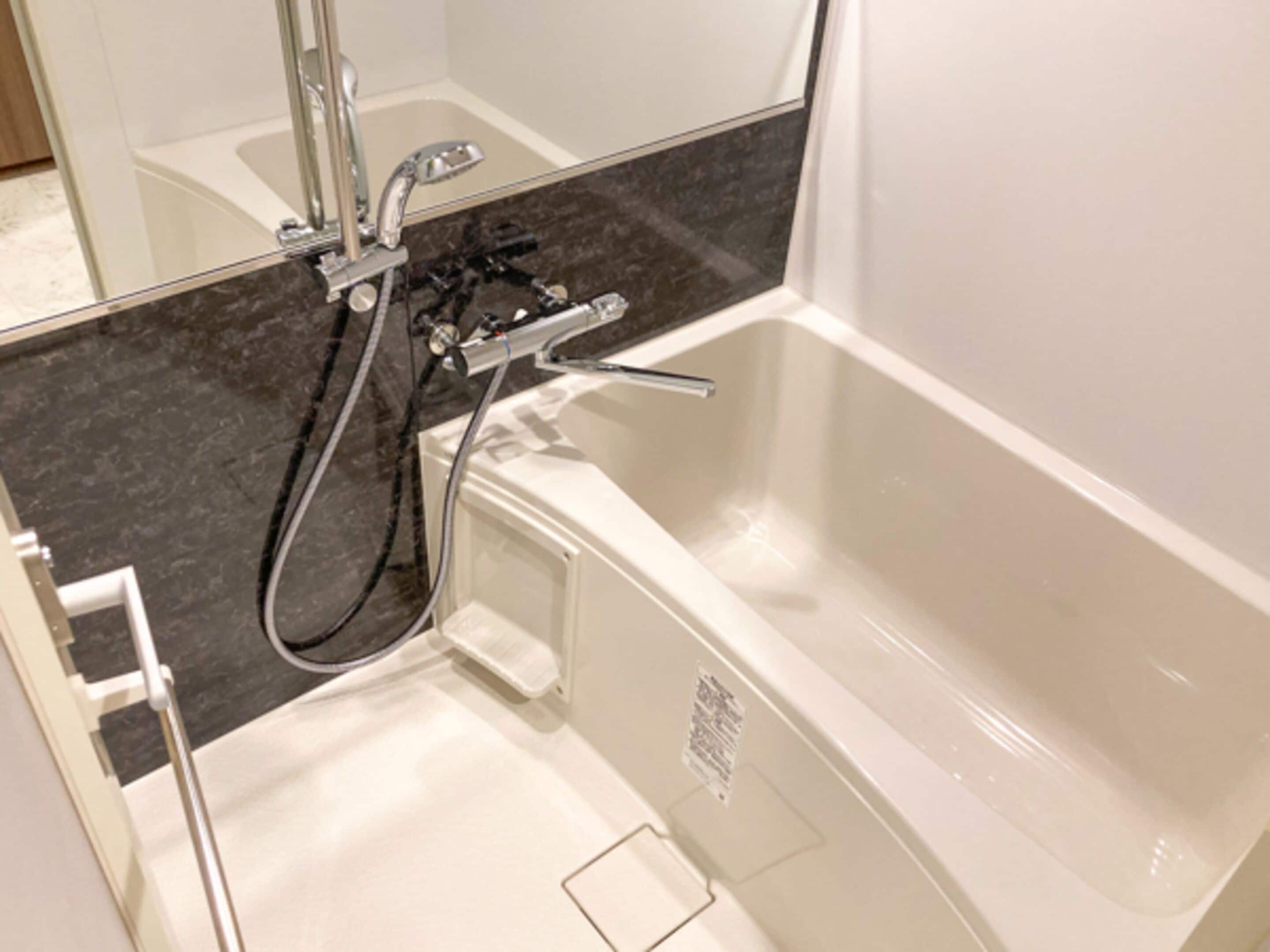 A bathroom with a bathtub, a shower, and a toilet.
