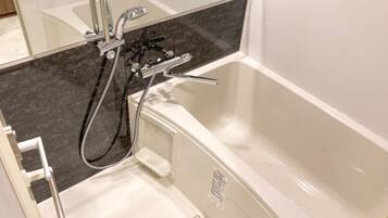 A bathroom with a bathtub, a shower, and a toilet.