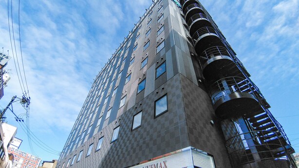 A multi-story hotel with a modern design, featuring a prominent 'HOTEL LIVEMAX' sign at the ground level. - Hotel Livemax Kokura-ekimae (Kitakyushu)