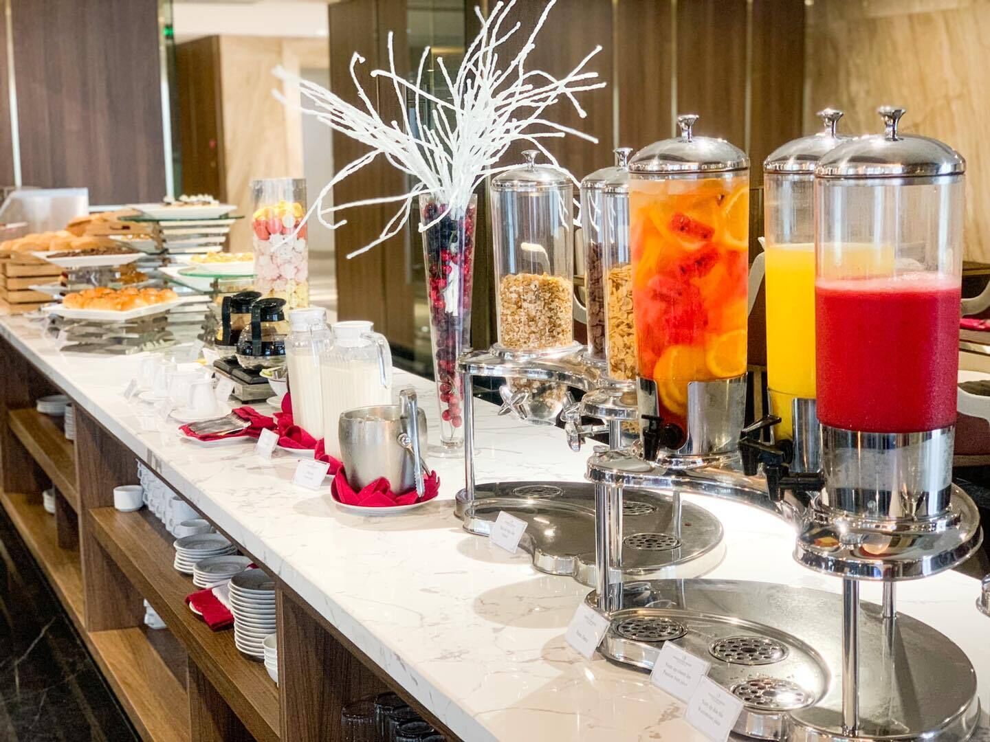 A buffet setup with various food items and beverages.