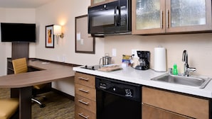 A compact hotel kitchen with a microwave, coffee maker, and dishwasher. - Candlewood Suites Lodi (Lodi)