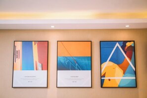 Three framed artworks on a wall. - Wei'erdun Hotel (Shenzhen Bao'an Lingzhi Metro Station) (Shenzhen)