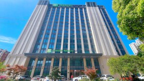A tall hotel building with a modern design, featuring a prominent 'Holiday Inn Express' sign at the top. - Holiday Inn Express Changzhou Xinbei (Changzhou)