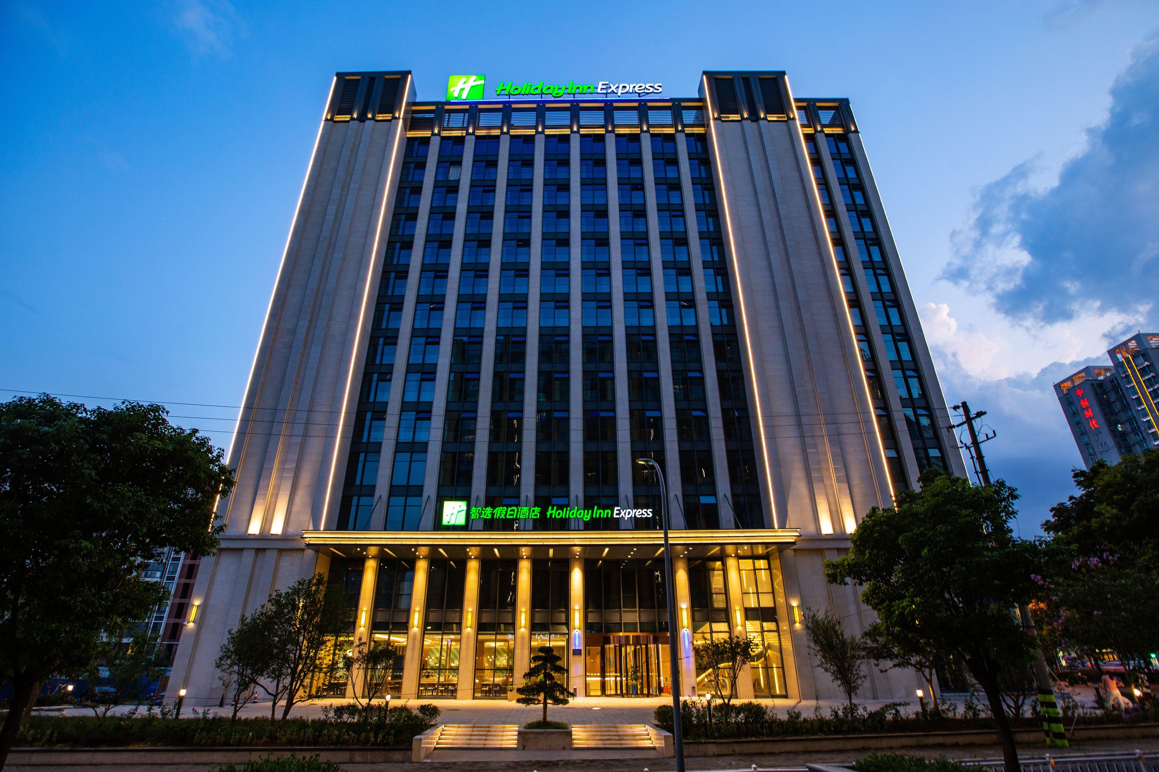 A tall hotel building with a prominent Holiday Inn Express sign at the top.