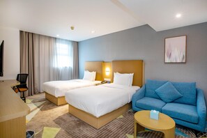 A hotel room with two beds, a sofa, a desk, and a television. - Holiday Inn Express Changzhou Xinbei (Changzhou)