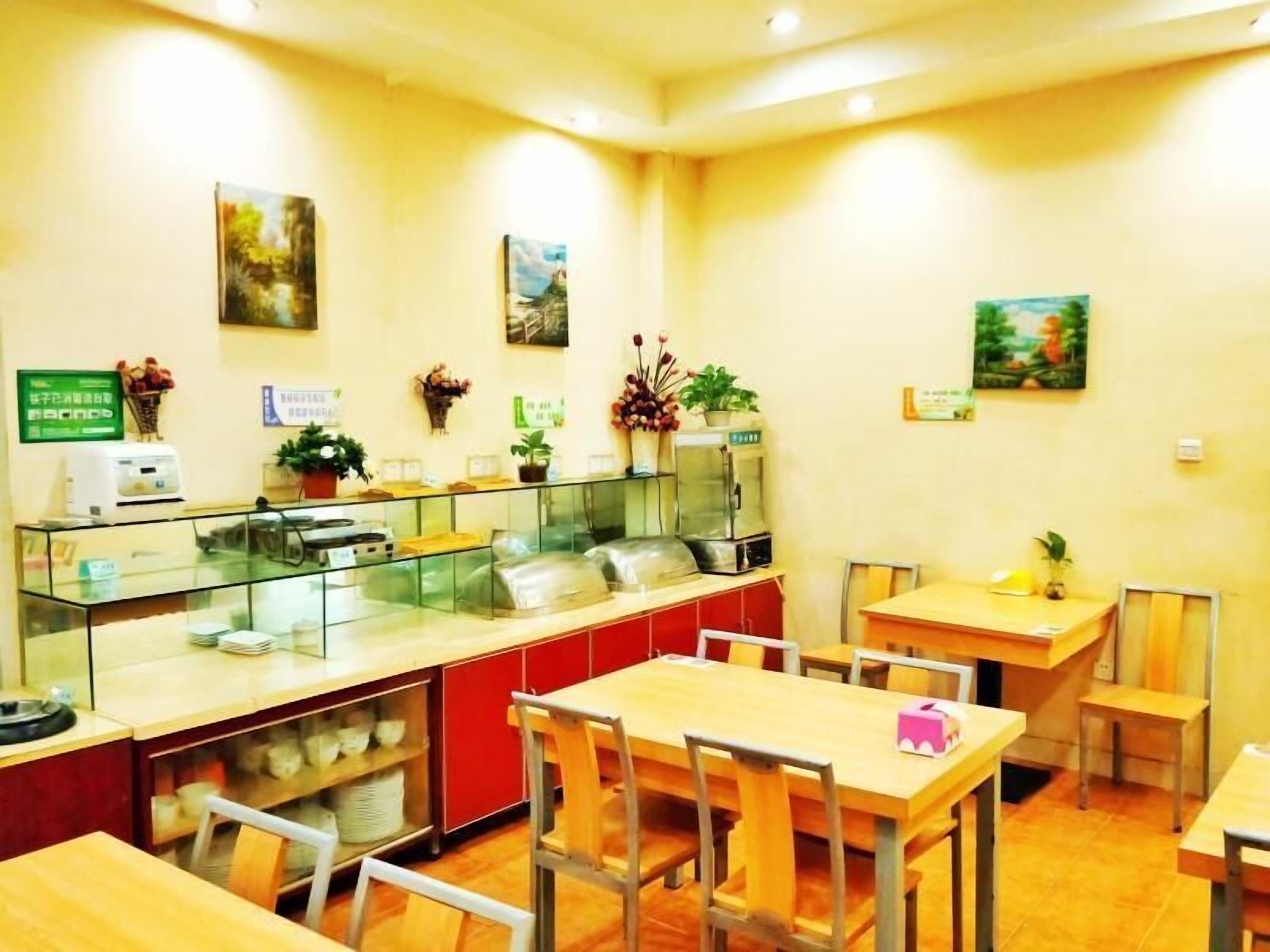 A restaurant with a counter, tables, chairs, and various decorations.