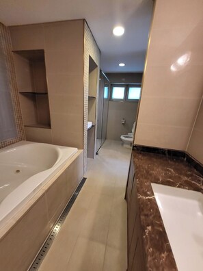 A modern bathroom with a large bathtub, a shower area, and a toilet. - Crystal Valley CC - Golden Village (Gapyeong)