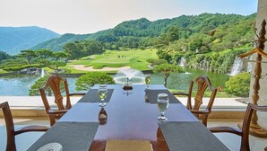 A table set for dining with a view of a golf course and a lake. - Crystal Valley CC - Golden Village (Gapyeong)