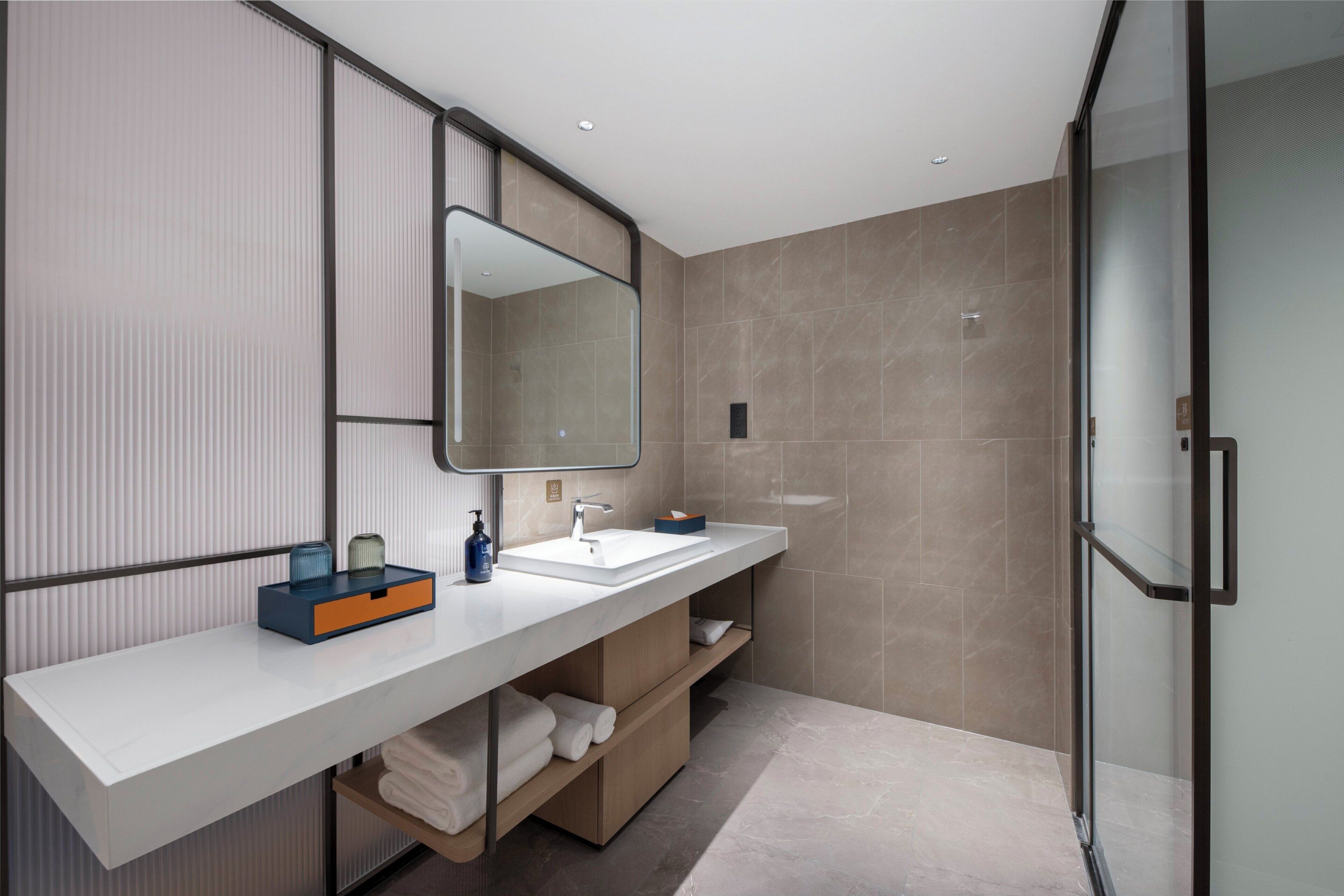 Shower, designer toiletries, hair dryer, slippers
