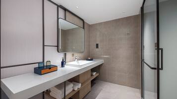 Shower, designer toiletries, hair dryer, slippers