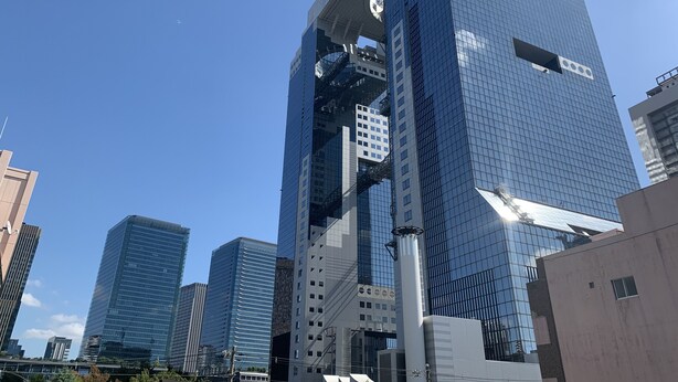 A modern high-rise building with a glass facade, surrounded by other tall buildings. - Rakuten STAY Osaka Station North (Osaka)