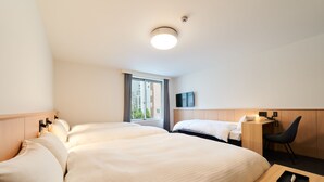 A hotel room with two beds, a desk, a chair, a TV, and a window with curtains. - Rakuten STAY Osaka Station North (Osaka)