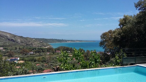 A swimming pool with a view of the sea and hills. - Lovely Open Plan Family Villa in Kato Katelios (Kefalonia)