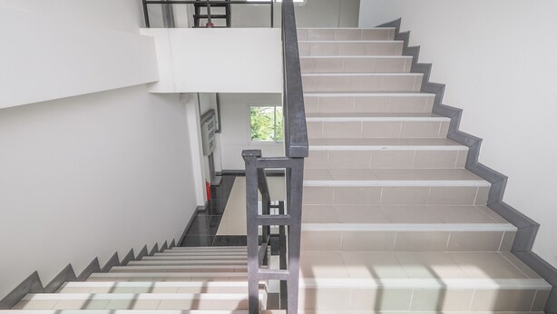 A staircase with a handrail, leading to an upper floor. - K&k Apartment (Bang Phli)