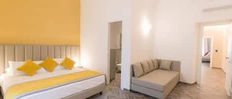 Deluxe Triple Room | Minibar, in-room safe, individually decorated, individually furnished