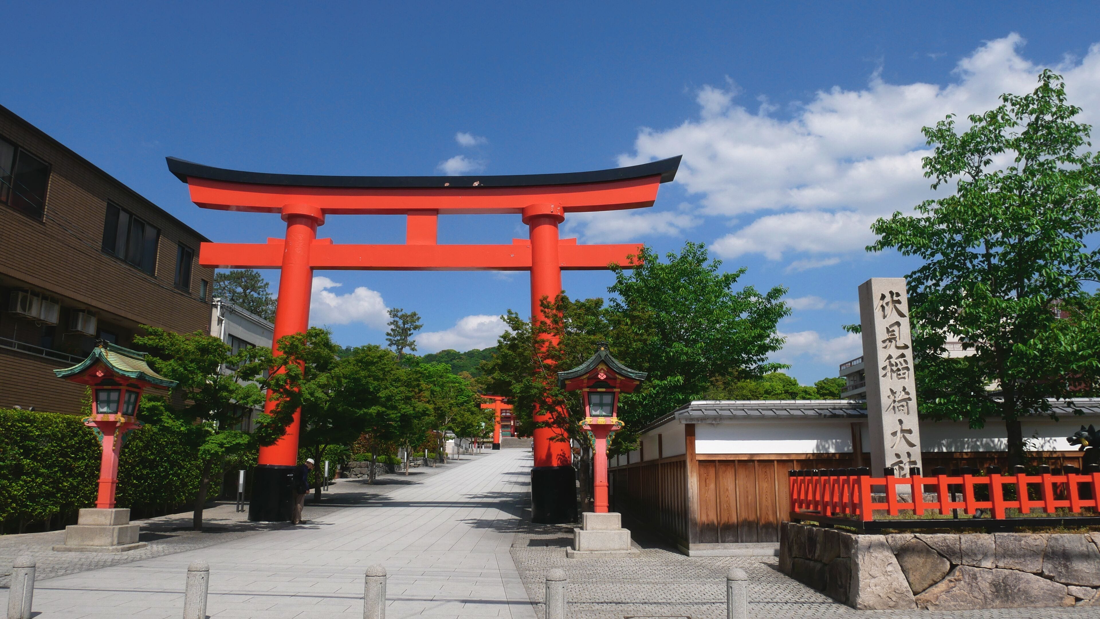 A traditional Japanese torii gate in a park with a clear sky.
