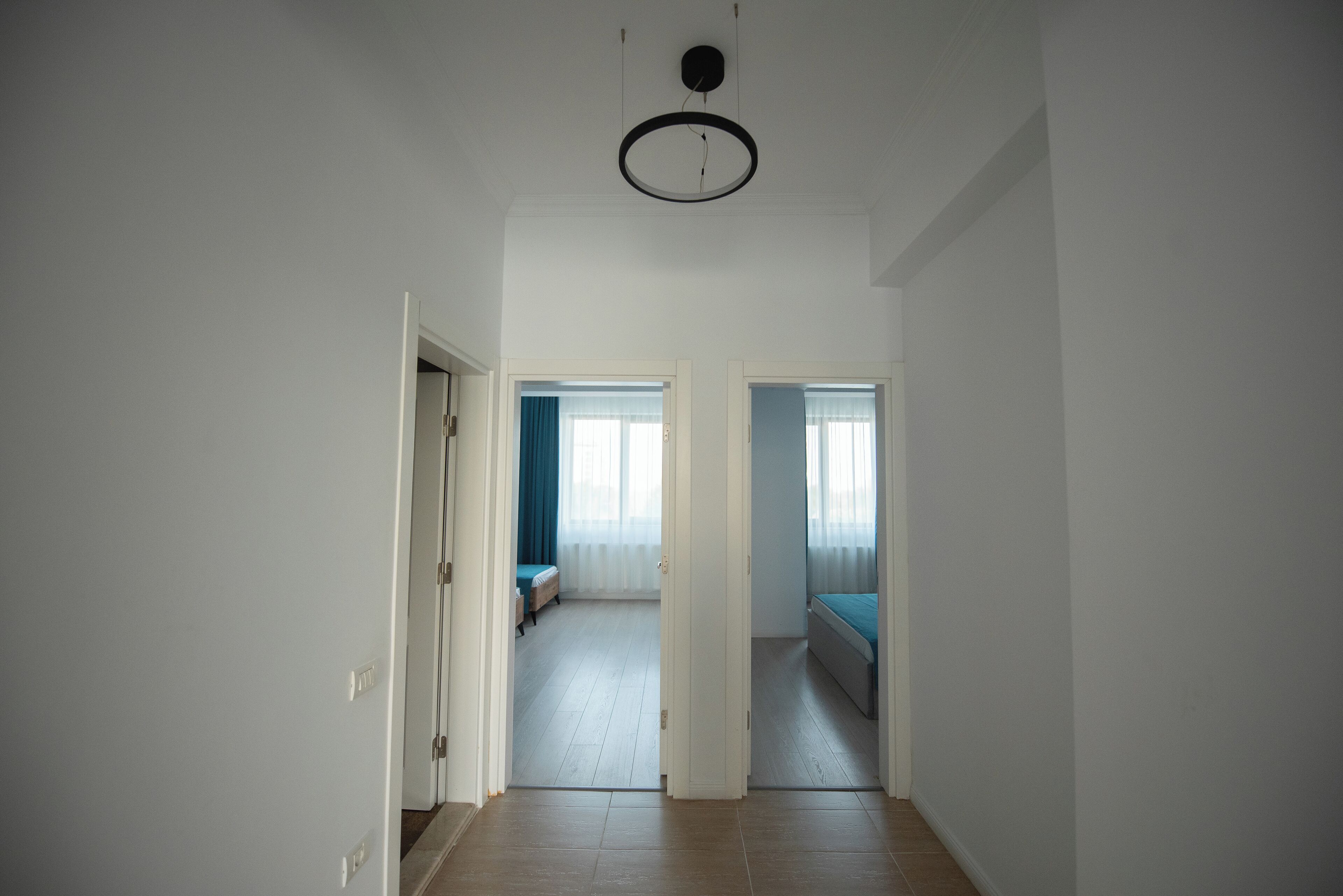 Un corridoio con un letto e una finestra sullo sfondo.