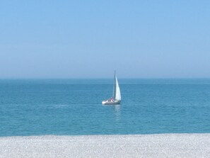 A sailboat on calm blue waters. - GOELAND Apartment with Ocean View and Large Balcony (MERS LES BAINS)