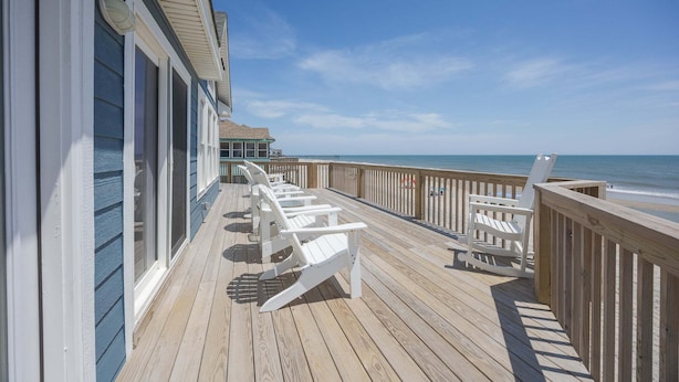 A wooden deck with white chairs and a railing overlooking the ocean. - 7048- Tide Song - Dog-Friendly Oceanfront Rodanthe Retreat (Rodanthe)