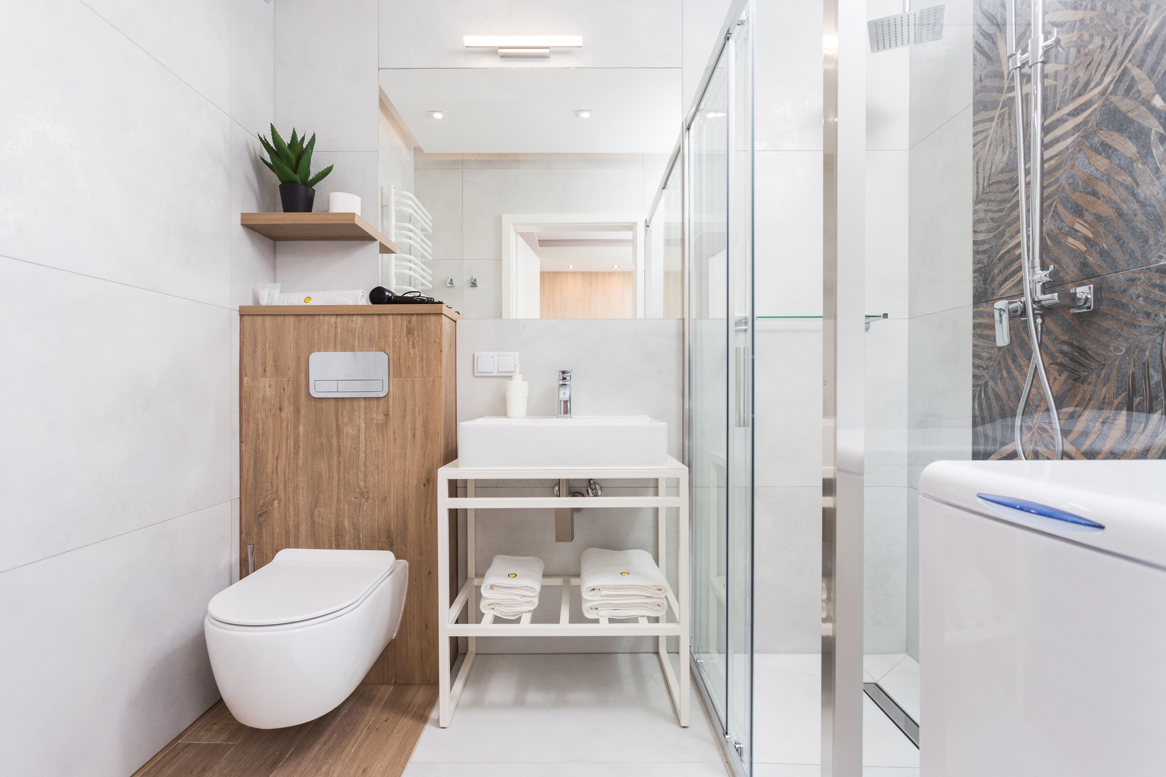 A modern bathroom with a toilet, sink, and shower area.