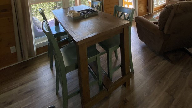 A wooden interior with a dining table, chairs, a sofa, and a ceiling fan. - Cottage by the creek, beautiful Mountain View, perfect getaway!!! (Estillfork)