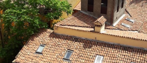 A building with multiple terracotta-tiled roofs and several small windows.