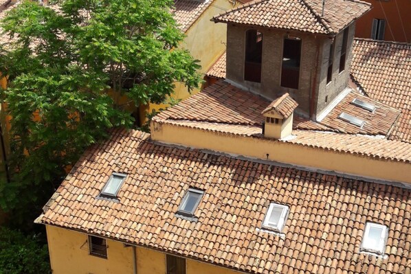 A building with multiple terracotta-tiled roofs and several small windows.