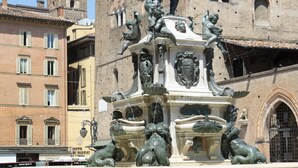 A historic fountain with multiple statues, surrounded by classic architecture.
