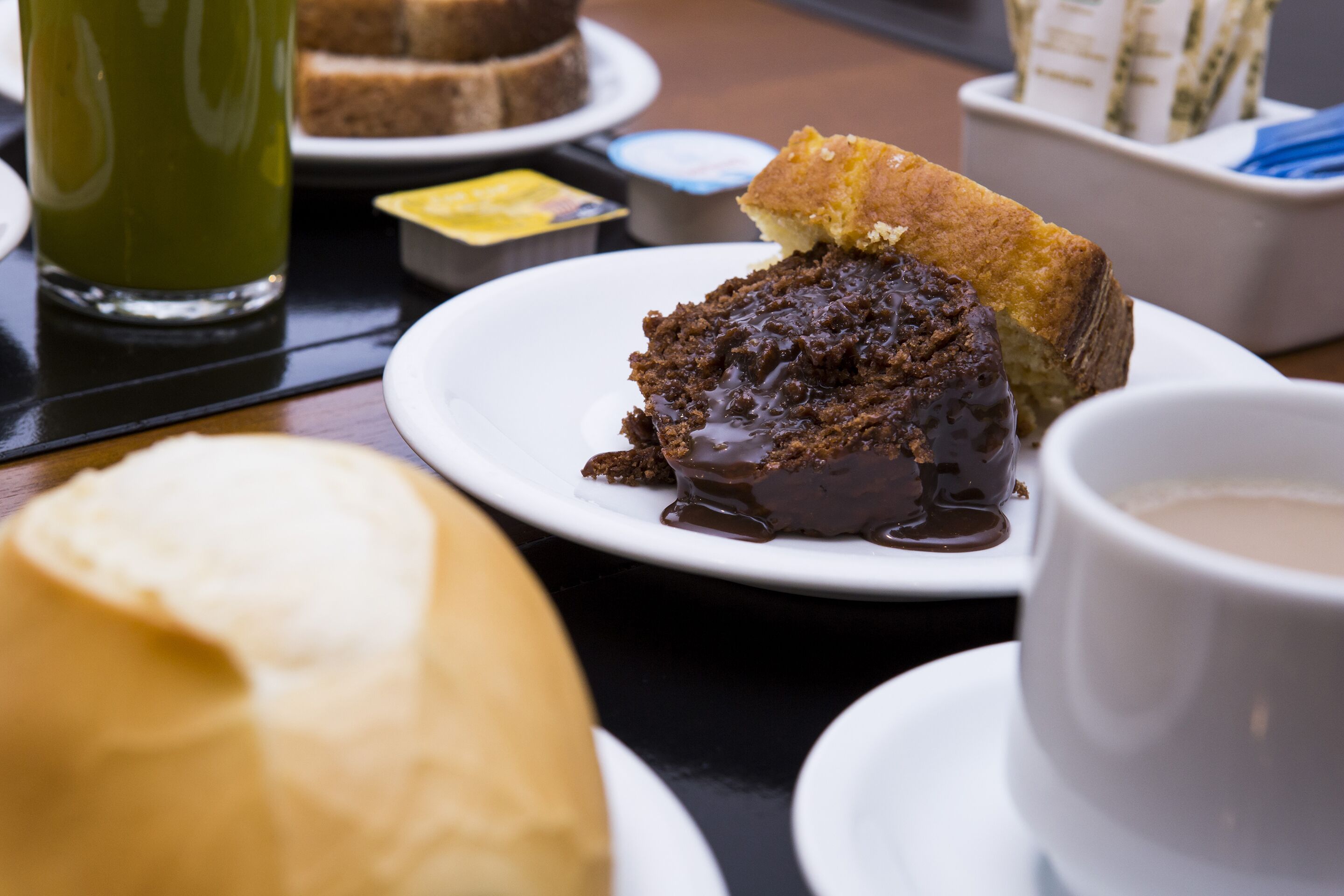 A dessert plate with a slice of cake and a cup of coffee.