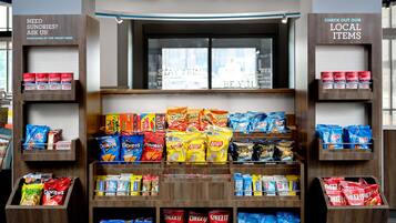 A snack display with various chips and cookies.