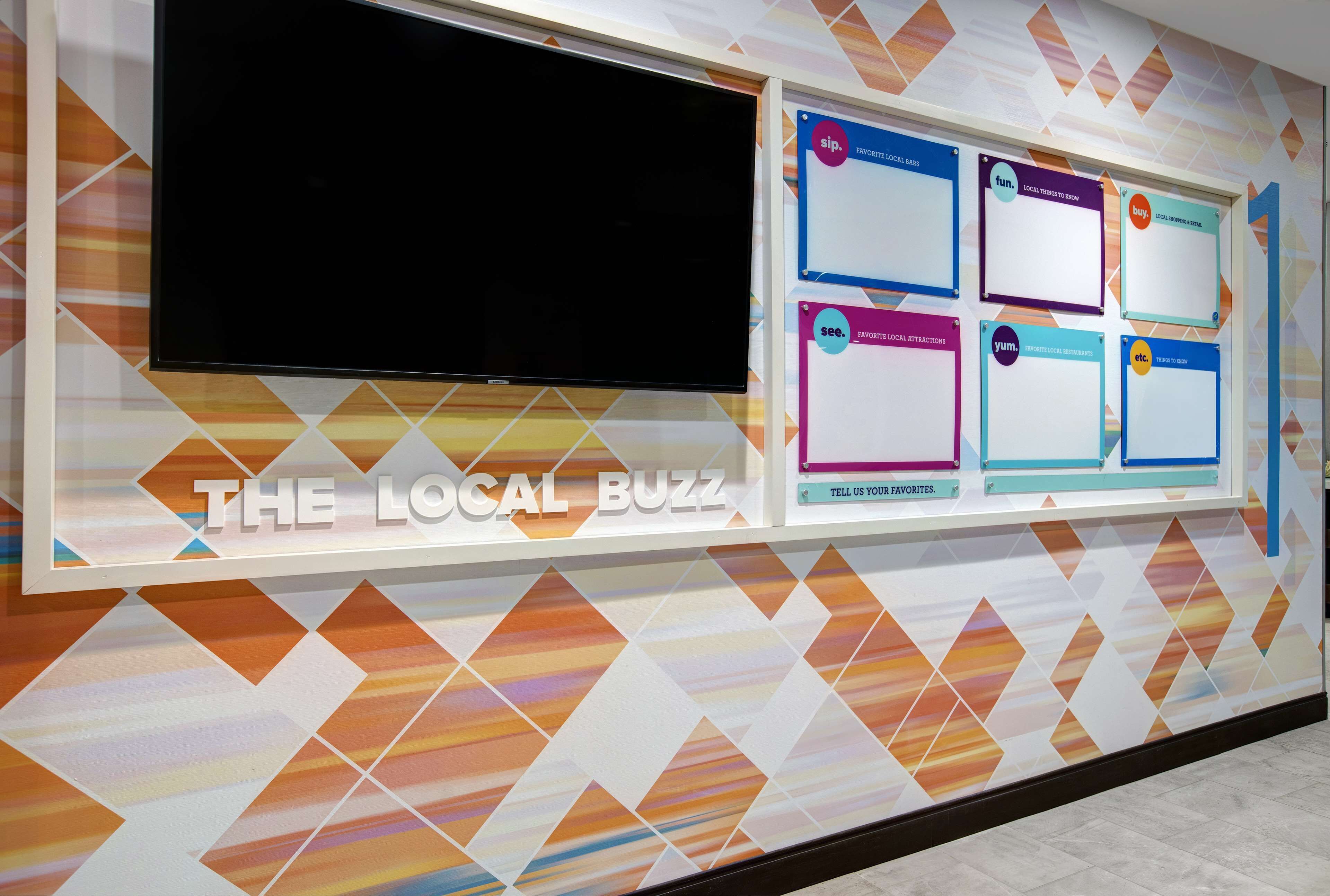 A bulletin board titled "THE LOCAL BUZZ" with various community boards and a large screen.