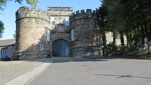 A historic stone building with a large wooden gate, likely a castle or fortress. - Albert Cottage, Skipton (Skipton)