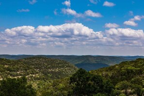 A landscape with rolling hills and a clear sky. - Miracle Lodge | Pool, Hot Tub & Scenic Views (Leakey)