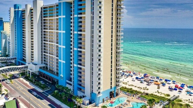 A high-rise hotel with multiple balconies overlooking a beach and ocean. - Don’t Worry, Beach Happy! 3rd Floor Beachfront Condo @ Majestic ~ Sleeps 8 (Panama City Beach)