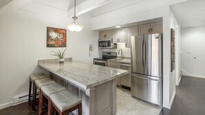 A modern kitchen with a central island, stainless steel appliances, and a hanging light fixture. - Ski-In/Ski-Out Park City Mountain Resort 1BR+Loft Sleeps 6-A/C & Fireplace (Park City)