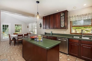 Enjoy cooking in this kitchen with a large island and ample workspace, featuring a window with a view of the outdoors.
