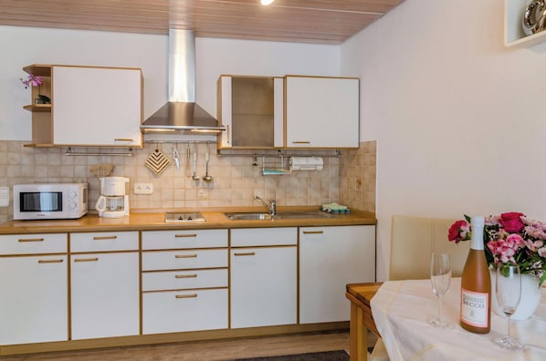 Fridge, microwave, stovetop, coffee/tea maker