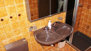 A bathroom with two sinks, a toilet, and a shower. - Tgèsa Palits Seehuber by Interhome (Sedrun)