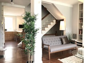 Relax in this stylish living space with a sofa, coffee table, and natural touches.