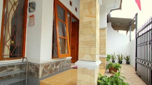 A building with a stone facade, a wooden door, and a metal gate.