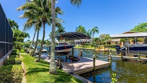 A marina with boats docked, a covered area, and a water canal.