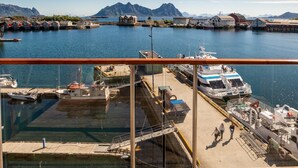 A harbor with boats docked, a large cruise ship, and a mountainous backdrop. - Nordis Apartments (Vagan)