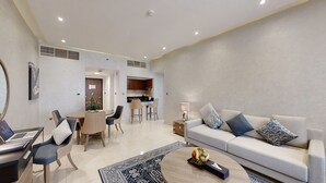 Un salon moderne avec un canapé, une table basse et un coin repas.