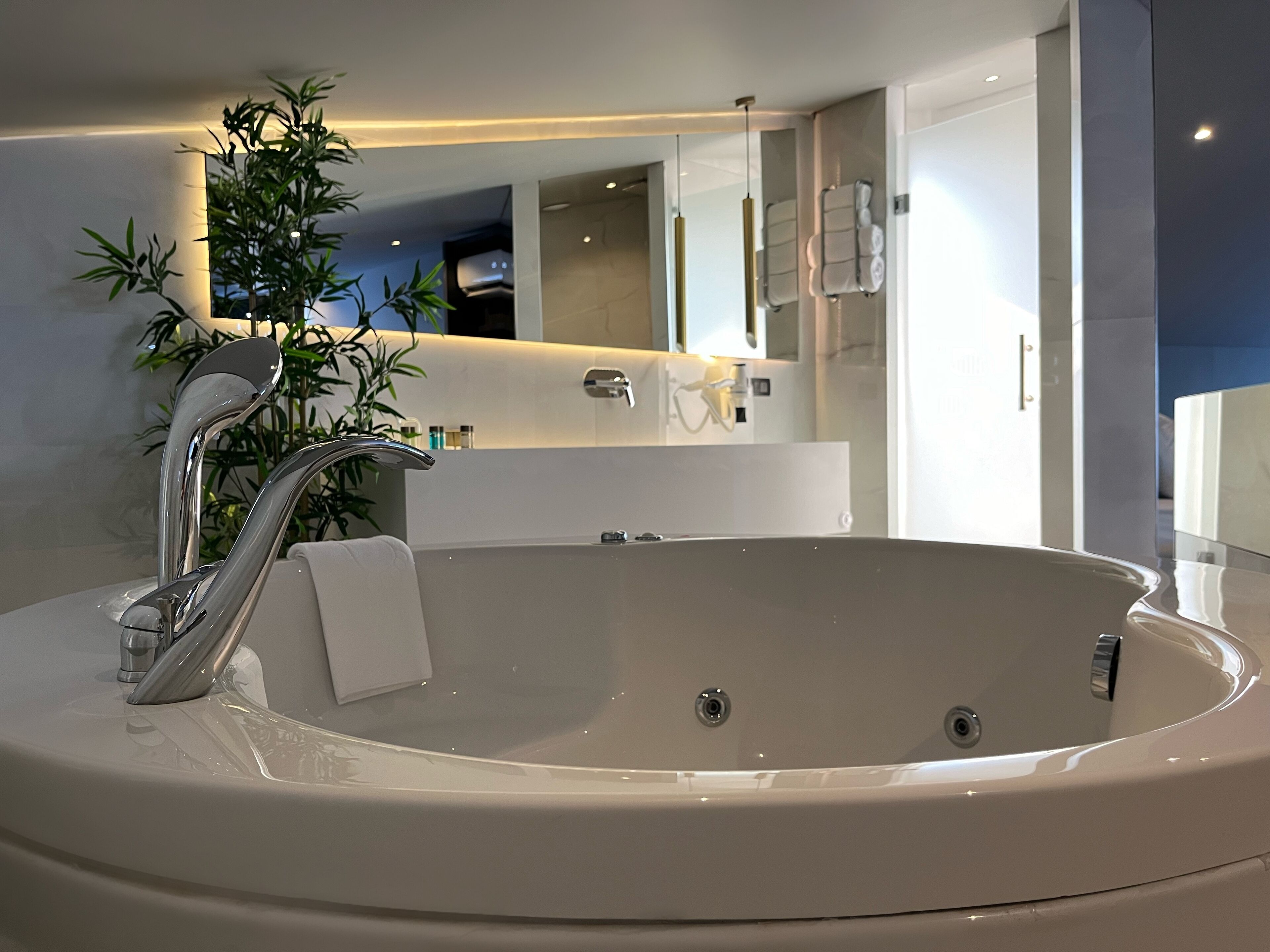 king suite | bathroom | designer toiletries, hair dryer, slippers, towels