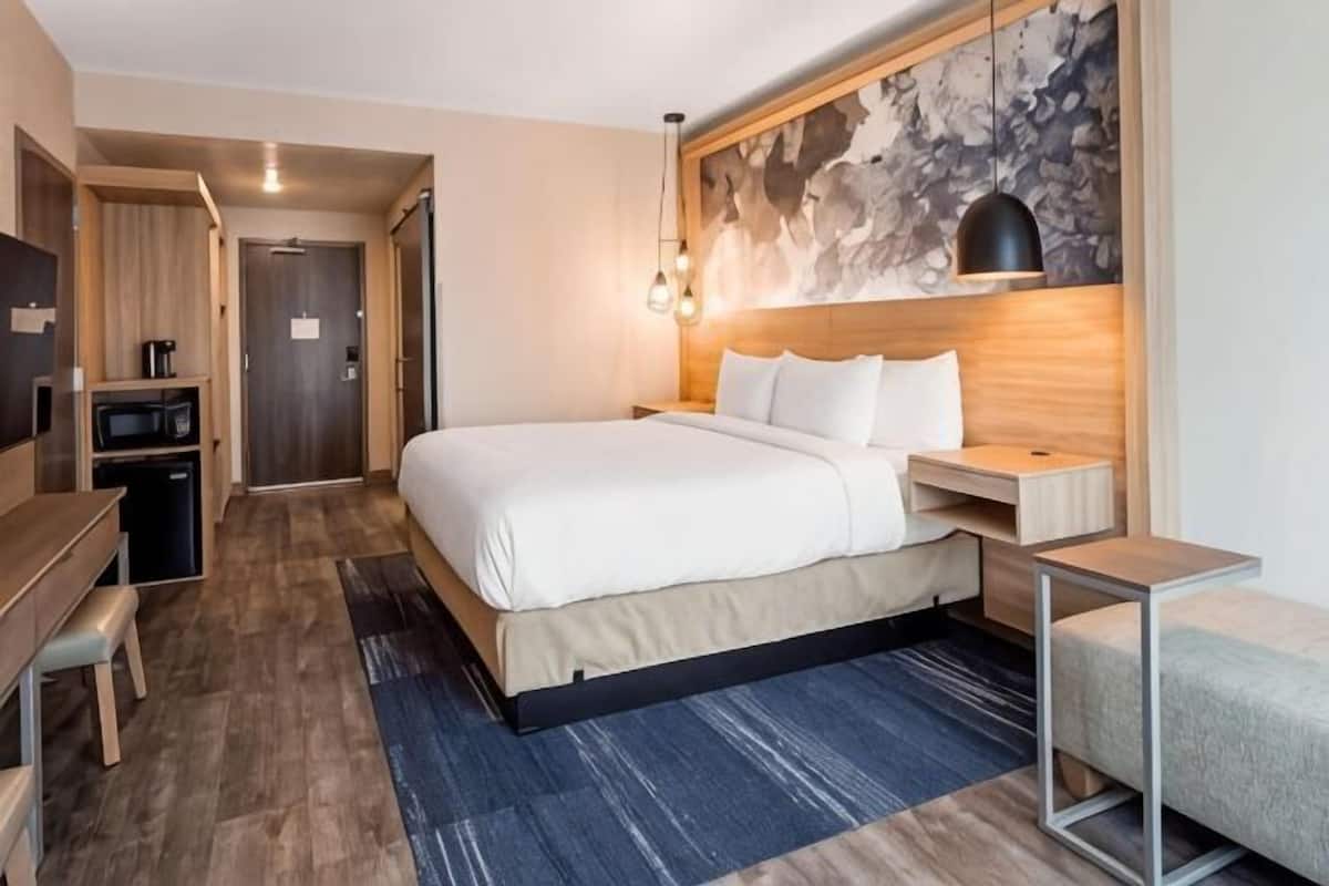 Desk, laptop workspace, blackout drapes, iron/ironing board